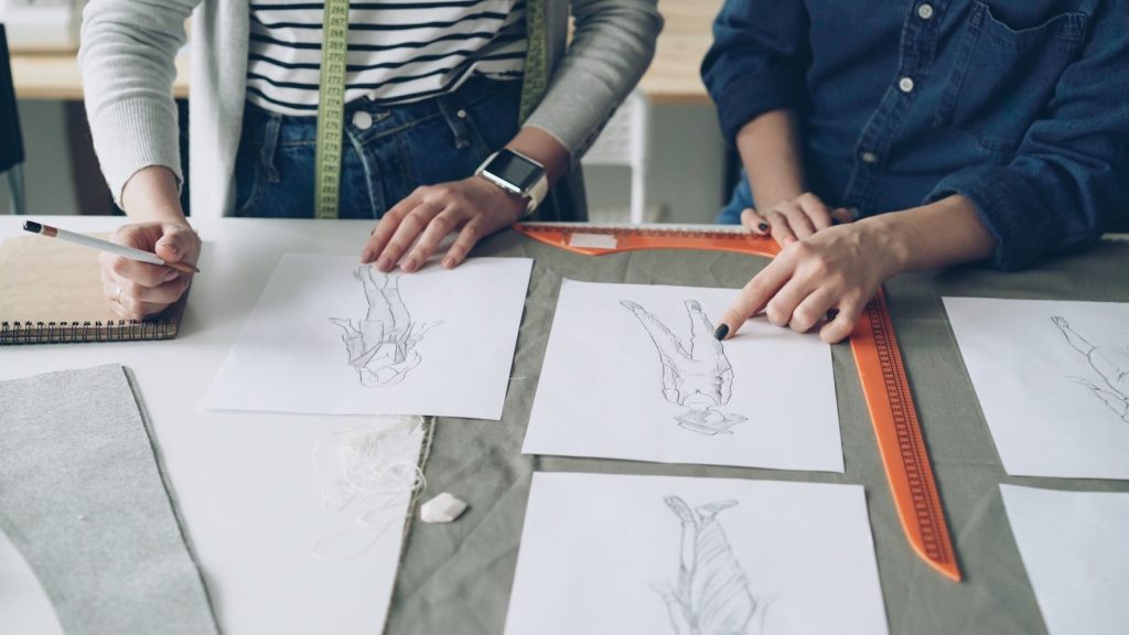 Designers collaborate on fashion sketches and plans