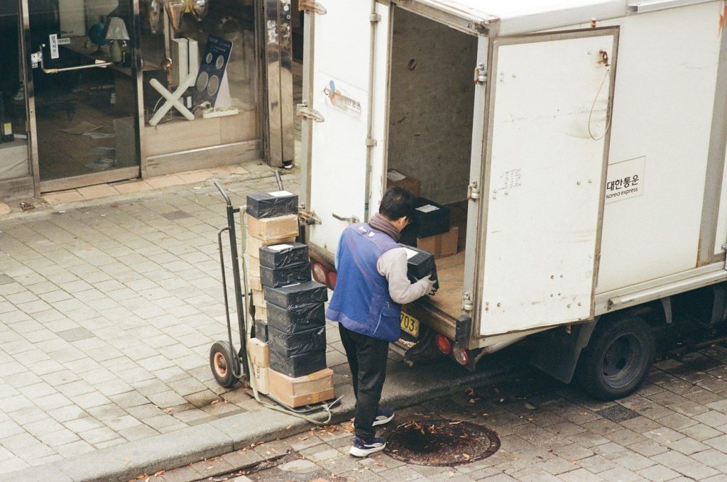 Man loading boxes from a truck onto a dolly