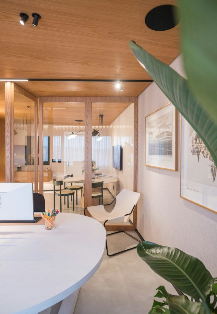 Modern office interior with glass walls and plants