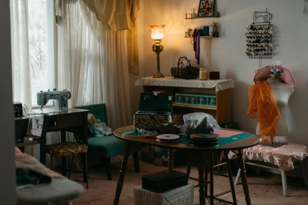 A sewing room with a vintage sewing machine and supplies